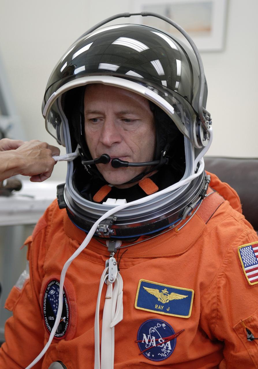 CAPE CANAVERAL, Fla. - STS-125 Pilot Gregory C. Johnson tries on his helmet for a fit check. Johnson will be making his first shuttle launch. His name patch reflects his military “call sign.” The crew is at NASA's Kennedy Space Center in Florida to take part in terminal countdown demonstration test, or TCDT, activities as preparation before launch on space shuttle Atlantis’ STS-125 mission to service NASA’s Hubble Space Telescope. TCDT provides astronauts and ground crews with an opportunity to participate in various simulated countdown activities, including equipment familiarization, emergency training and a launch countdown. Atlantis is targeted to launch Oct. 14. Photo credit: NASA/Kim Shiflett