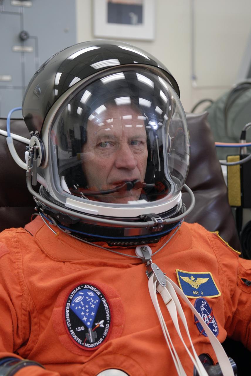 CAPE CANAVERAL, Fla. - STS-125 Pilot Gregory C. Johnson tries on his helmet for a fit check. Johnson will be making his first shuttle launch. His name patch reflects his military “call sign.” The crew is at NASA's Kennedy Space Center in Florida to take part in terminal countdown demonstration test, or TCDT, activities as preparation before launch on space shuttle Atlantis’ STS-125 mission to service NASA’s Hubble Space Telescope. TCDT provides astronauts and ground crews with an opportunity to participate in various simulated countdown activities, including equipment familiarization, emergency training and a launch countdown. Atlantis is targeted to launch Oct. 14. Photo credit: NASA/Kim Shiflett