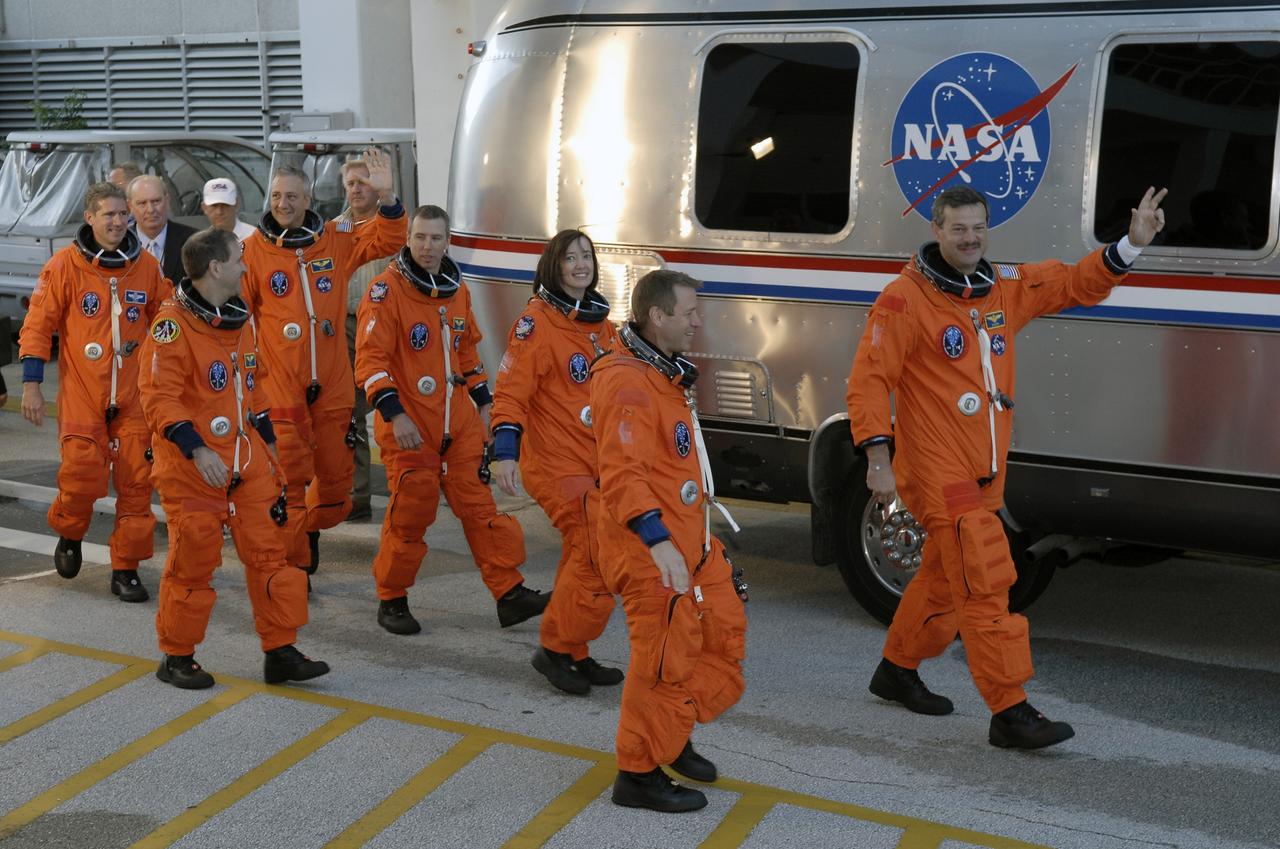 CAPE CANAVERAL, Fla. -   The STS-125 crew heads for the Astrovan after suiting up in the Operations and Checkout Building at NASA's Kennedy Space Center in Florida.  From left are Mission Specialists Michael Good, John Grunsfeld, Mike Massimino, Andrew Feustel and Megan McArthur, Pilot Gregory C. Johnson and Commander Scott Altman. The crew is heading for Launch Pad 39A where they will take part in a simulated launch countdown aboard space shuttle Atlantis. The countdown is the culmination of terminal countdown demonstration test, or TCDT, activities as preparation before launch.  TCDT provides astronauts and ground crews with an opportunity to participate in various simulated countdown activities, including equipment familiarization, emergency training and the countdown.  Atlantis’ STS-125 mission to service NASA’s Hubble Space Telescope is targeted for launch Oct. 14.  Photo credit: NASA/Kim Shiflett