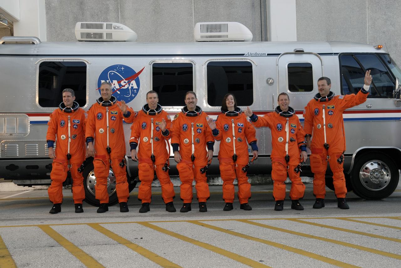 CAPE CANAVERAL, Fla. -   The STS-125 crew lines up outside the Astrovan after suiting up in the Operations and Checkout Building at NASA's Kennedy Space Center in Florida.  From left are Mission Specialists Michael Good, Mike Massimino, Andrew Feustel, John Grunsfeld and Megan McArthur, Pilot Gregory C. Johnson and Commander Scott Altman.  The crew is heading for Launch Pad 39A where they will take part in a simulated launch countdown aboard space shuttle Atlantis. The countdown is the culmination of terminal countdown demonstration test, or TCDT, activities as preparation before launch.  TCDT provides astronauts and ground crews with an opportunity to participate in various simulated countdown activities, including equipment familiarization, emergency training and the countdown.  Atlantis’ STS-125 mission to service NASA’s Hubble Space Telescope is targeted for launch Oct. 14.  Photo credit: NASA/Kim Shiflett