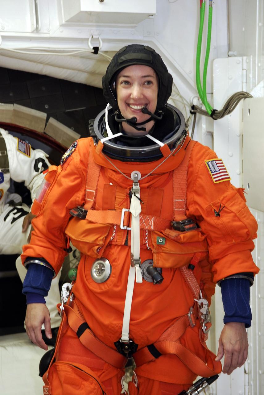 CAPE CANAVERAL, Fla. -  STS-125 Mission Specialist Megan McArthur is ready to enter the hatch into space shuttle Atlantis for a simulated launch countdown.  The countdown is the culmination of terminal countdown demonstration test, or TCDT, activities as preparation before launch.  TCDT provides astronauts and ground crews with an opportunity to participate in various launch activities, including equipment familiarization, emergency training and the countdown.  Atlantis’ STS-125 mission to service NASA’s Hubble Space Telescope is targeted for launch Oct. 14.  Photo credit: NASA/Amanda Diller