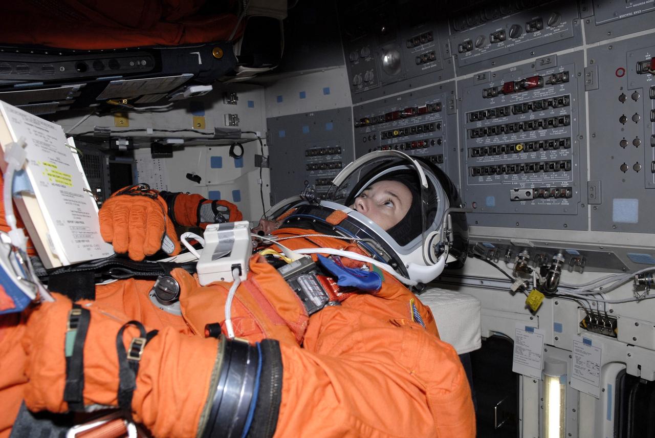 CAPE CANAVERAL, Fla. - The STS-125 crew is taking part in a simulated launch countdown aboard space shuttle Atlantis at NASA's Kennedy Space Center in Florida. Seen in her seat in the mid-deck is Mission Specialist Megan McArthur. The countdown is the culmination of terminal countdown demonstration test, or TCDT, activities as preparation before launch. TCDT provides astronauts and ground crews with an opportunity to participate in various launch activities, including equipment familiarization, emergency training and the countdown. Atlantis’ STS-125 mission to service NASA’s Hubble Space Telescope is targeted for launch Oct. 14. Photo credit: NASA/Kim Shiflett