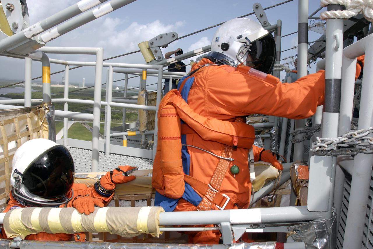 CAPE CANAVERAL, Fla. - After taking part in a simulated launch countdown aboard space shuttle Atlantis, the STS-125 crew members practice an emergency escape from the shuttle. Here they are ready to release the slidewire basket that will speed them away from Kennedy Space Center’s Launch Pad 39A. The countdown is the culmination of terminal countdown demonstration test, or TCDT, activities as preparation before launch. TCDT provides astronauts and ground crews with an opportunity to participate in various launch activities, including equipment familiarization, emergency training and the countdown. Atlantis’ STS-125 mission to service NASA’s Hubble Space Telescope is targeted for launch Oct. 14. Photo credit: NASA/Kim Shiflett
