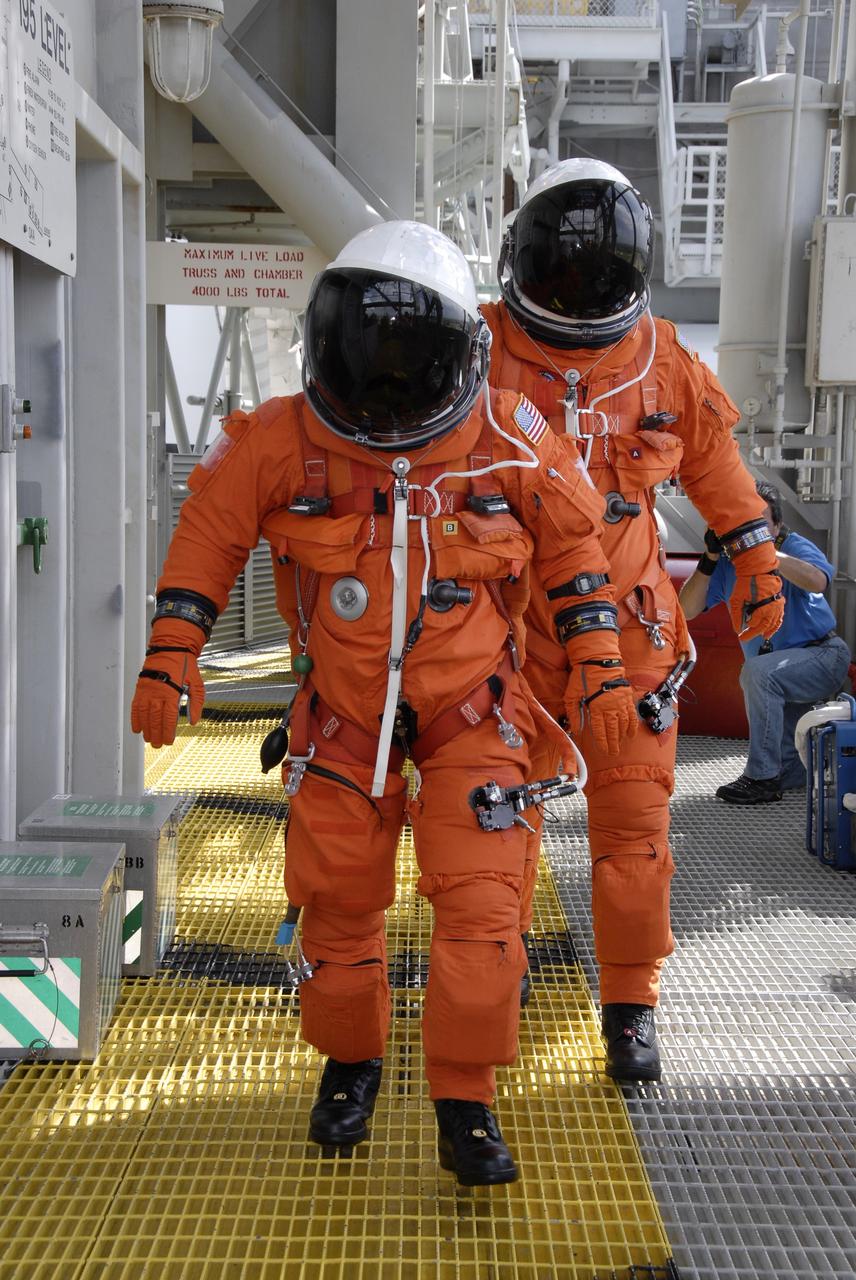CAPE CANAVERAL, Fla. - After taking part in a simulated launch countdown aboard space shuttle Atlantis, the STS-125 crew members practice an emergency escape from the shuttle. They are heading for the slidewire baskets that on the fixed service structure that will speed them away from Kennedy Space Center’s Launch Pad 39A. The countdown is the culmination of terminal countdown demonstration test, or TCDT, activities as preparation before launch. TCDT provides astronauts and ground crews with an opportunity to participate in various launch activities, including equipment familiarization, emergency training and the countdown. Atlantis’ STS-125 mission to service NASA’s Hubble Space Telescope is targeted for launch Oct. 14. Photo credit: NASA/Kim Shiflett