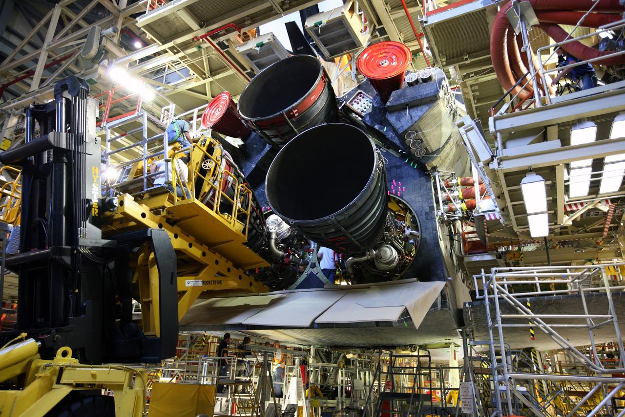 CAPE CANAVERAL, Fla. - Using the Hyster forklift, workers move space shuttle main engine No. 3 during installation in space shuttle Discovery in Orbiter Processing Facility bay 3 at NASA's Kennedy Space Center in Florida. Each engine is 14 feet long, weighs about 6,700 pounds, and is 7.5 feet in diameter at the end of the nozzle. Discovery is being processed for its next mission, STS-119, targeted for launch on Feb. 12, 2009. Discovery and its crew will deliver integrated truss structure 6 (S6) and solar arrays to the International Space Station. Photo credit: NASA/Dimitri Gerondidakis
