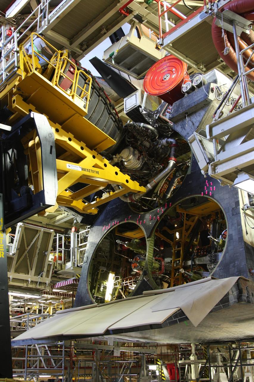 CAPE CANAVERAL, Fla. - Using a Hyster forklift, workers install space shuttle main engine No. 1 (top) in space shuttle Discovery in Orbiter Processing Facility bay 3 at NASA's Kennedy Space Center in Florida.  Each engine is 14 feet long, weighs about 6,700 pounds, and is 7.5 feet in diameter at the end of the nozzle. Discovery is being processed for its next mission, STS-119, targeted for launch on Feb. 12, 2009. Discovery and its crew will deliver integrated truss structure 6 (S6) and solar arrays to the International Space Station. Photo credit: NASA/Dimitri Gerondidakis