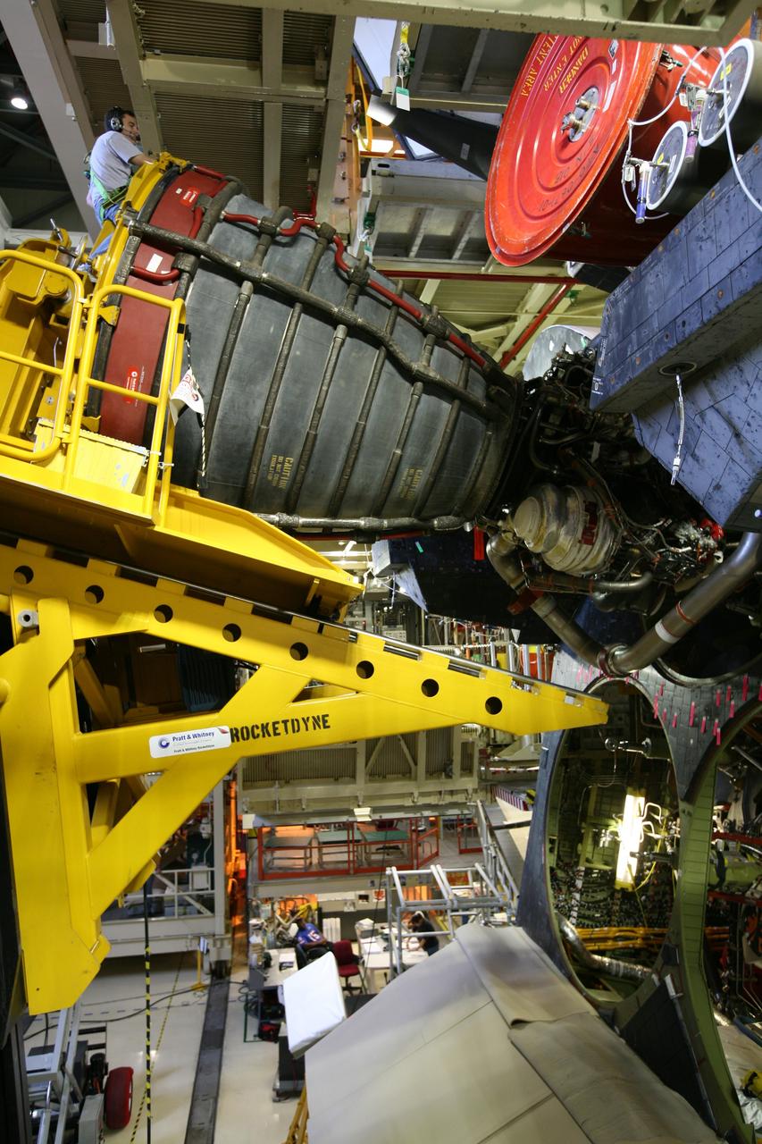 CAPE CANAVERAL, Fla. - In Orbiter Processing Facility bay 3 at NASA's Kennedy Space Center in Florida, a Hyster forklift (near top) moves space shuttle main engine No. 1 closer to space shuttle Discovery for installation.  Each engine is 14 feet long, weighs about 6,700 pounds, and is 7.5 feet in diameter at the end of the nozzle. Discovery is being processed for its next mission, STS-119, targeted for launch on Feb. 12, 2009. Discovery and its crew will deliver integrated truss structure 6 (S6) and solar arrays to the International Space Station. Photo credit: NASA/Dimitri Gerondidakis