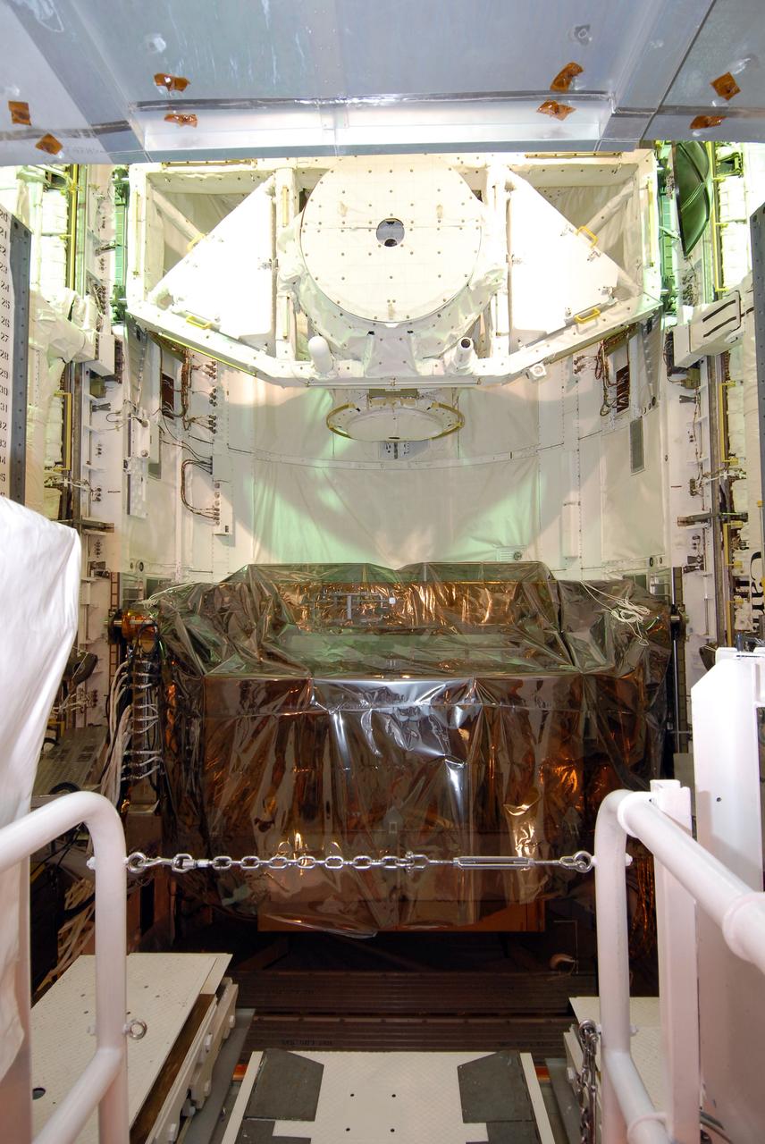 CAPE CANAVERAL, Fla. -  On Launch Pad 39A at NASA's Kennedy Space Center in Florida, the Super Lightweight Interchangeable Carrier is installed behind the shuttle external airlock (top) in space shuttle Atlantis’ payload bay for the STS-125 mission.  STS-125 is the fifth and final shuttle servicing mission for NASA’s Hubble Space Telescope.  The payload comprises four carriers holding various equipment for the mission. Atlantis is targeted to launch Oct. 14 on the 11-day mission.  Photo credit: NASA/Jack Pfaller