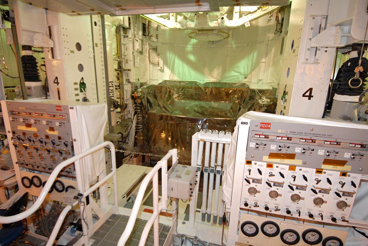 CAPE CANAVERAL, Fla. - Viewed from inside the Payload Changeout Room on Launch Pad 39A at NASA's Kennedy Space Center in Florida, the Super Lightweight Interchangeable Carrier is installed behind the shuttle external airlock (top) in space shuttle Atlantis’ payload bay for the STS-125 mission. STS-125 is the fifth and final shuttle servicing mission for NASA’s Hubble Space Telescope. The payload comprises four carriers holding various equipment for the mission. Atlantis is targeted to launch Oct. 14 on the 11-day mission. Photo credit: NASA/Jack Pfaller