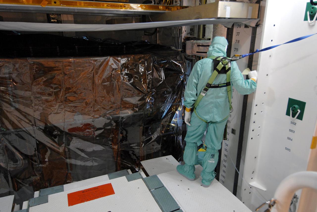 CAPE CANAVERAL, Fla. -   In the Payload Changeout Room on Launch Pad 39A at NASA's Kennedy Space Center in Florida, a worker uses the payload ground handling mechanism to install the payload for the STS-125 mission into space shuttle Atlantis’ payload bay.  STS-125 is the fifth and final shuttle servicing mission for NASA’s Hubble Space Telescope.  The payload comprises four carriers holding various equipment for the mission. Atlantis is targeted to launch Oct. 14 on the 11-day mission.  Photo credit: NASA/Jack Pfaller