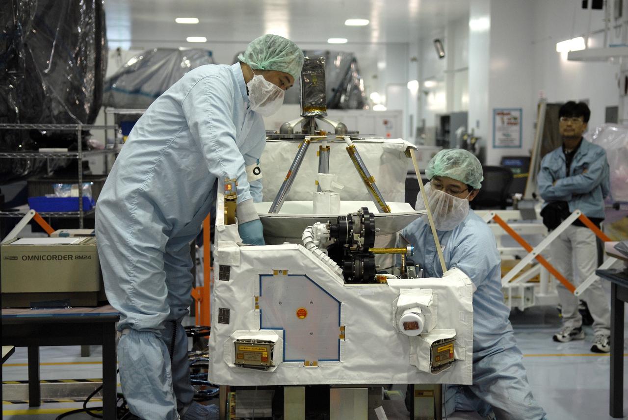 CAPE CANAVERAL, Fla. - In the Space Station Processing Facility at NASA's Kennedy Space Center in Florida, Japanese Aerospace Exploration Agency, or JAXA, technicians begin to deploy an antenna from the Inter Orbit Communication System Extended Facility, or ICS-EF. The antenna and a pointing mechanism will be used to communicate with JAXA’s Data Relay Test Satellite, or DRTS. The ICS-EF will be launched, along with the Extended Facility and Experiment Logistics Module-Exposed Section, to the International Space Station aboard the space shuttle Endeavour on the STS-127mission targeted for launch on May 15, 2009. Photo credit: NASA/Kim Shiflett