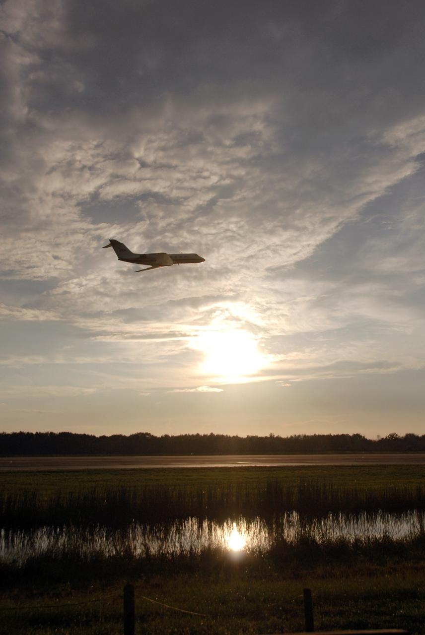 CAPE CANAVERAL, Fla. -  The Shuttle Training Aircraft, or STA, piloted by space shuttle Endeavour’s STS-126 commander, Chris Ferguson, is silhouetted against the cloudy gray sky and setting sun over NASA's Kennedy Space Center in Florida.  Ferguson is flying the STA to practice landing a shuttle on the runway of the Shuttle Landing Facility. The STA is a Grumman American Aviation-built Gulf Stream II jet that was modified to simulate a shuttle’s cockpit, motion and visual cues, and handling qualities. In flight, the aircraft duplicates the shuttle’s atmospheric descent trajectory from approximately 35,000 feet altitude to landing on a runway. Ferguson previously served as pilot on the STS-115 mission, which flew in September 2006.  The STS-126 mission to the International Space Station is targeted to launch Nov. 16.  Photo credit: NASA/Cory Huston