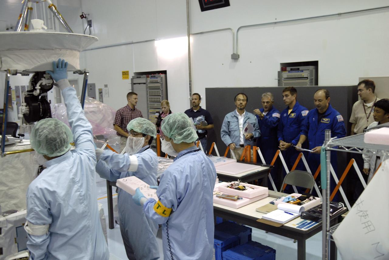 CAPE CANAVERAL, Fla. - In the Space Station Processing Facility at NASA's Kennedy Space Center in Florida, STS-127 crew members get a look at the extended antenna (upper left) in the Inter Orbit Communication System Extended Facility, or ICS-EF. Standing next to a Japanese Aerospace Exploration Agency, or JAXA, technician (at center) are (from left) Mission Specialists Dave Wolf and Christopher Cassidy and Commander Mark Polansky. Equipment familiarization is part of a Crew Equipment Interface Test. The antenna and a pointing mechanism will be used to communicate with JAXA’s Data Relay Test Satellite, or DRTS. The ICS-EF will be launched, along with the Extended Facility and Experiment Logistics Module-Exposed Section, to the International Space Station aboard the space shuttle Endeavour on the STS-127 mission targeted for launch on May 15, 2009. Photo credit: NASA/Kim Shiflett