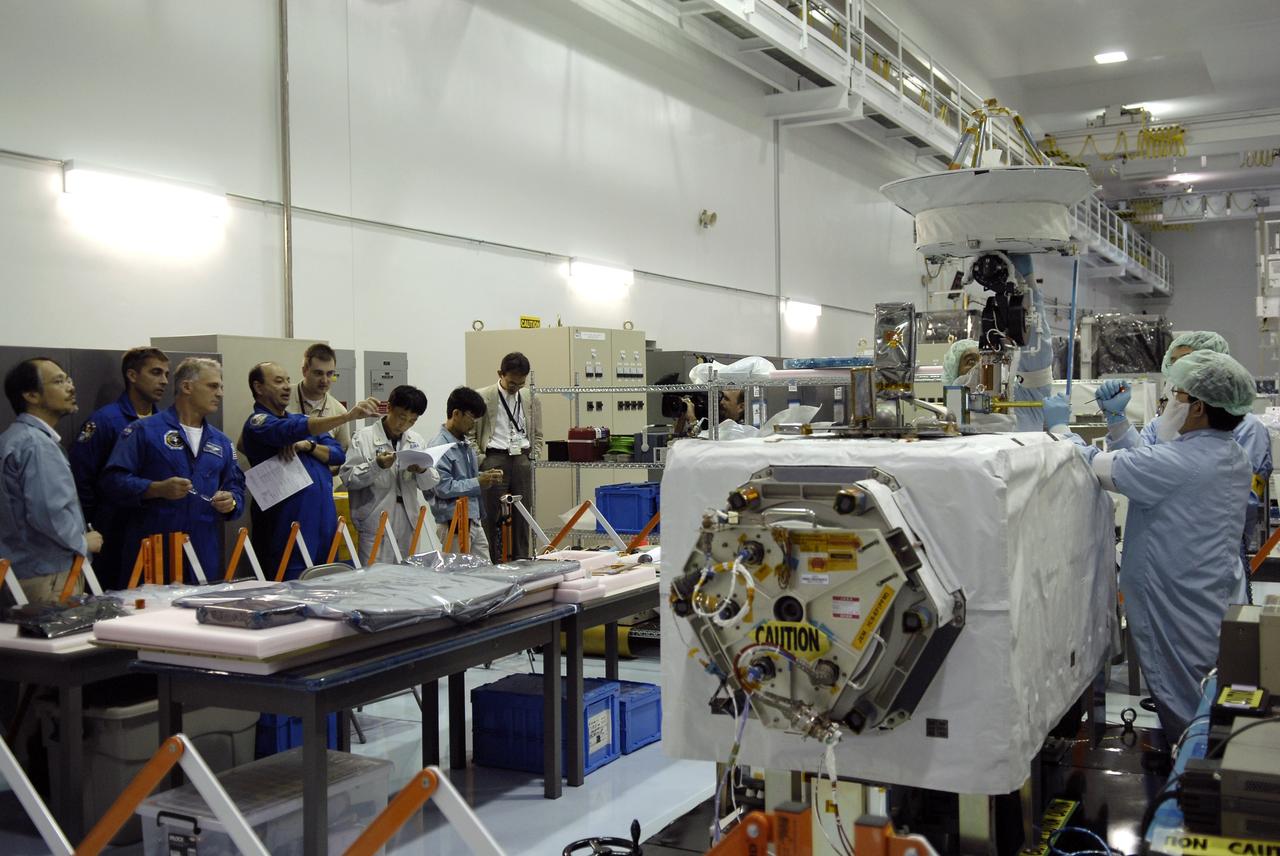 CAPE CANAVERAL, Fla. - In the Space Station Processing Facility at NASA's Kennedy Space Center in Florida, STS-127 crew members get a look at the extended antenna in the Inter Orbit Communication System Extended Facility, or ICS-EF, across from them. Standing next to a Japanese Aerospace Exploration Agency, or JAXA, technician at left are Mission Specialists Christopher Cassidy and Dave Wolf and Commander Mark Polansky (pointing). Equipment familiarization is part of a Crew Equipment Interface Test. The antenna and a pointing mechanism will be used to communicate with JAXA’s Data Relay Test Satellite, or DRTS. The ICS-EF will be launched, along with the Extended Facility and Experiment Logistics Module-Exposed Section, to the International Space Station aboard the space shuttle Endeavour on the STS-127 mission targeted for launch on May 15, 2009. Photo credit: NASA/Kim Shiflett