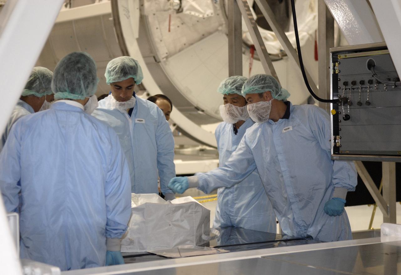 CAPE CANAVERAL, Fla. -   In the Space Station Processing Facility at NASA's Kennedy Space Center in Florida, STS-127 crew members get a close look at equipment for their mission, which will install final components of the Japanese Aerospace Exploration Agency’s Japanese Experiment Module, or JEM.  Equipment familiarization is part of a Crew Equipment Interface Test. The JEM components include the Inter Orbit Communication System Extended Facility, or ICS-EF, the Extended Facility and Experiment Logistics Module-Exposed Section. The payload will launch aboard  space shuttle Endeavour targeted for May 15, 2009. Photo credit: NASA/Kim Shiflett