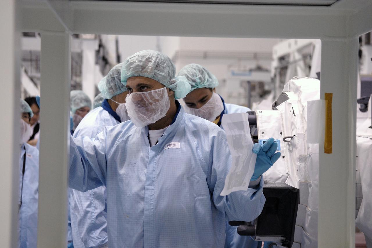 CAPE CANAVERAL, Fla. -   In the Space Station Processing Facility at NASA's Kennedy Space Center in Florida, STS-127 crew members become familiar with the payload and hardware for their mission.  Here they are looking at the Experiment Logistics Module - Exposed Section, or ELM-ES, berthing mechanism. The mission payload also includes the Extended Facility and the Inter Orbit Communication System Extended Facility, or ICS-EF.  Equipment familiarization is part of a Crew Equipment Interface Test. The payload will be launched to the International Space Station aboard the space shuttle Endeavour on the STS-127 mission, targeted for launch on May 15, 2009.  Photo credit: NASA/Kim Shiflett
