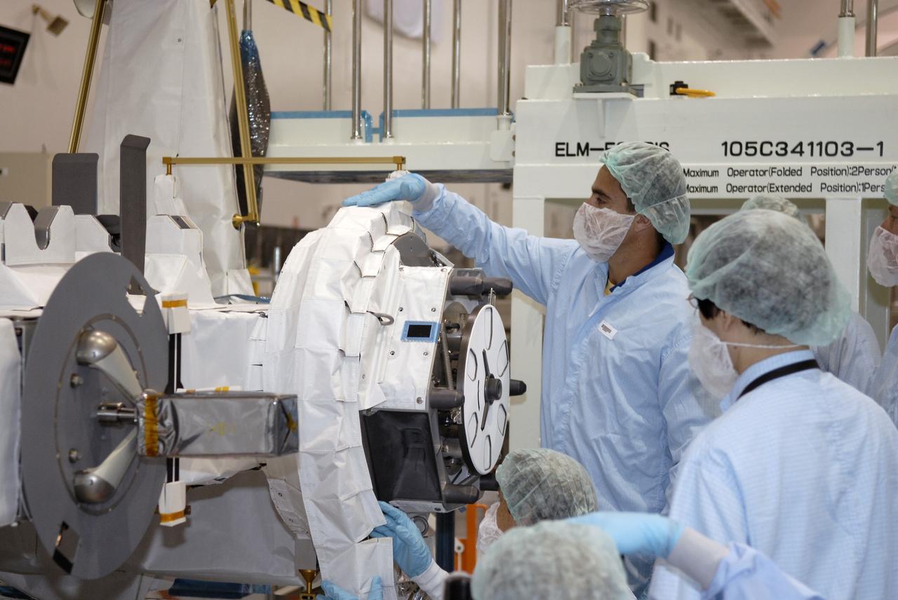 CAPE CANAVERAL, Fla. -   In the Space Station Processing Facility at NASA's Kennedy Space Center in Florida, STS-127 crew members become familiar with the payload and hardware for their mission.  Here they are looking at the Experiment Logistics Module - Exposed Section, or ELM-ES, berthing mechanism. The mission payload also includes the Extended Facility and the Inter Orbit Communication System Extended Facility, or ICS-EF.  Equipment familiarization is part of a Crew Equipment Interface Test. The payload will be launched to the International Space Station aboard the space shuttle Endeavour on the STS-127 mission, targeted for launch on May 15, 2009.  Photo credit: NASA/Kim Shiflett