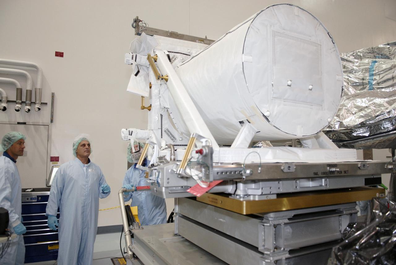 CAPE CANAVERAL, Fla. -  In the Space Station Processing Facility at NASA's Kennedy Space Center in Florida, STS-127 crew members become familiar with the payload and hardware for their mission.  Seen at left are Mission Specialists Tom Marshburn and Dave Wolf.   Here they are looking at the Space-to-Ground ANTenna, or SGANT, Flight Support Equipment that will fly on the Integrated Cargo Carrier.  The mission payload also includes the Extended Facility and the Inter Orbit Communication System Extended Facility, or ICS-EF.  Equipment familiarization is part of a Crew Equipment Interface Test. The payload will be launched to the International Space Station aboard the space shuttle Endeavour on the STS-127 mission, targeted for launch on May 15, 2009.  Photo credit: NASA/Kim Shiflett