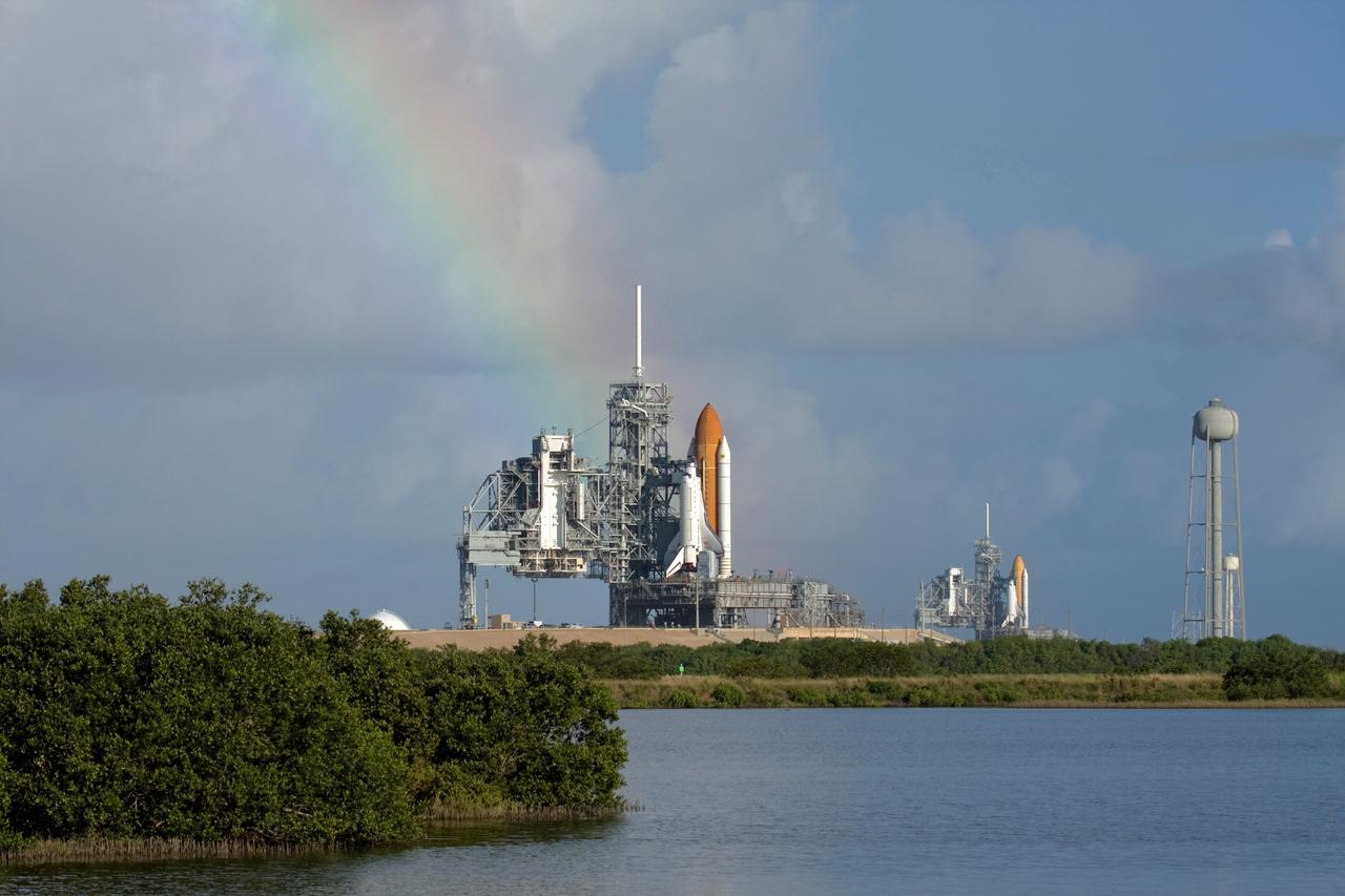 CAPE CANAVERAL, Fla. -  A rainbow completes this unique panorama of two space shuttles on the launch pads at the same time, the first time since July 2001. At upper right is STS-126 mission’s space shuttle Endeavour, which rolled out Sept. 19.  At left is space shuttle Atlantis, preparing for its launch on the STS-125 mission to repair NASA's Hubble Space Telescope, targeted for Oct. 10.  Endeavour will stand by at pad B in the unlikely event that a rescue mission is necessary during space shuttle Atlantis' upcoming mission. After Endeavour is cleared from its duty as a rescue spacecraft, it will be moved to Launch Pad 39A for the STS-126 mission to the International Space Station. That flight is targeted for launch Nov. 12.  Photo courtesy of NASA.