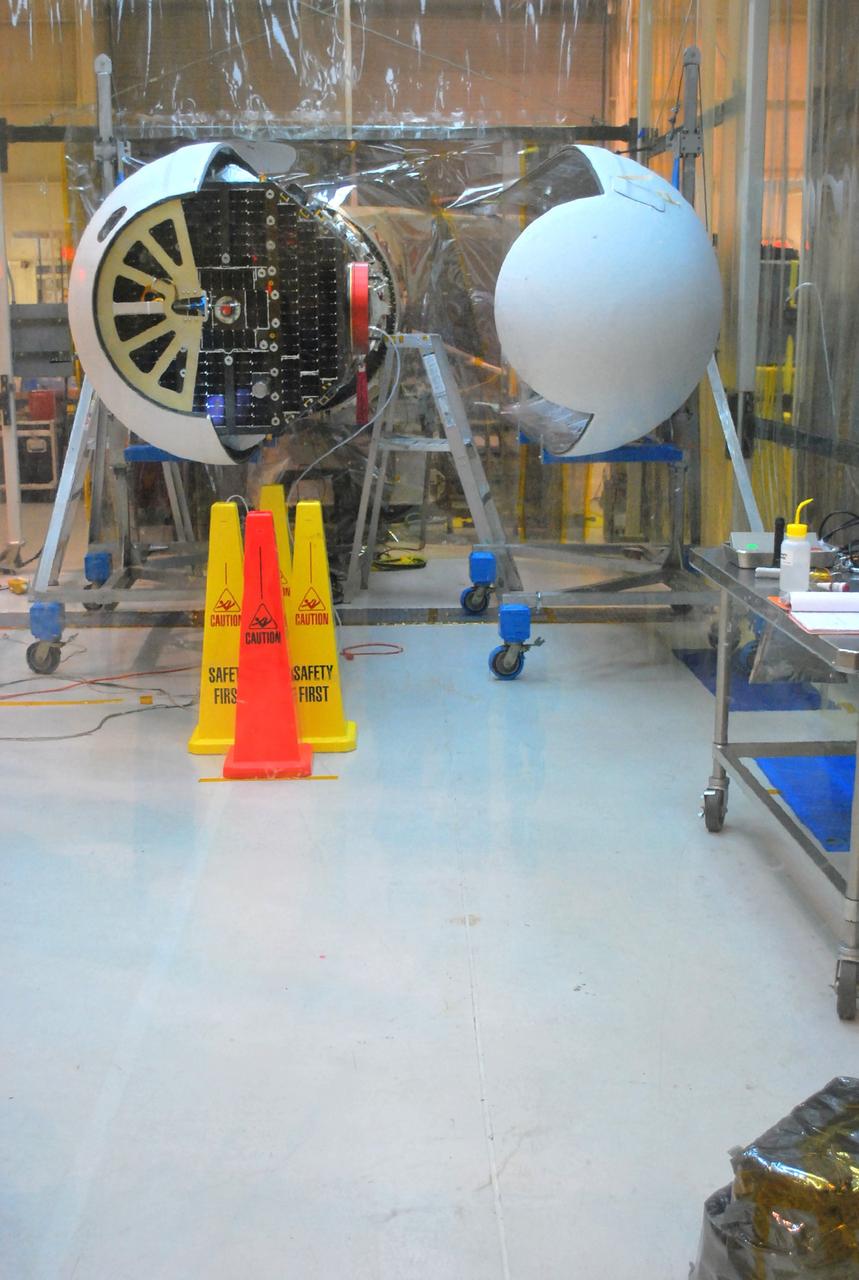 VANDENBERG AIR FORCE BASE, Calif. –   Inside a protected clean room tent on Vandenberg Air Force Base in California, the second half of the fairing is ready for installation around NASA’s Interstellar Boundary Explorer, or IBEX, spacecraft. The fairing is a molded structure that fits flush with the outside surface of the rocket and forms an aerodynamically smooth nose cone, protecting the spacecraft during launch and ascent. The IBEX satellite will make the first map of the boundary between the Solar System and interstellar space. IBEX is targeted for launch from the Kwajalein Atoll, a part of the Marshall Islands in the Pacific Ocean, on Oct.  19.  IBEX will be launched aboard a Pegasus rocket dropped from under the wing of an L-1011 aircraft flying over the Pacific Ocean. The Pegasus will carry the spacecraft approximately 130 miles above Earth and place it in orbit.  Photo credit: NASA/Randy Beaudoin, VAFB
