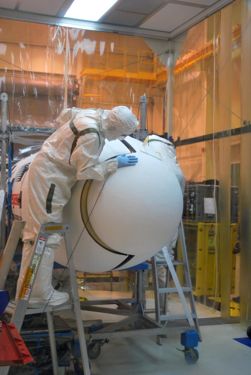 VANDENBERG AIR FORCE BASE, Calif. –   Inside a protected clean room tent on Vandenberg Air Force Base in California, both halves of the fairing have been installed around NASA’s Interstellar Boundary Explorer, or IBEX, spacecraft. The fairing is a molded structure that fits flush with the outside surface of the rocket and forms an aerodynamically smooth nose cone, protecting the spacecraft during launch and ascent. The IBEX satellite will make the first map of the boundary between the Solar System and interstellar space. IBEX is targeted for launch from the Kwajalein Atoll, a part of the Marshall Islands in the Pacific Ocean, on Oct.  19.  IBEX will be launched aboard a Pegasus rocket dropped from under the wing of an L-1011 aircraft flying over the Pacific Ocean. The Pegasus will carry the spacecraft approximately 130 miles above Earth and place it in orbit.  Photo credit: NASA/Randy Beaudoin, VAFB