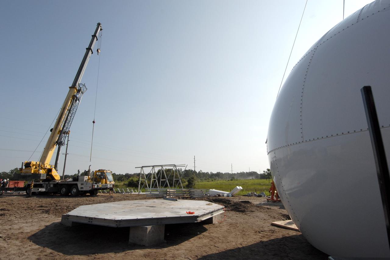 CAPE CANAVERAL, Fla. -    Construction continues on the Doppler weather radar facility for the 45th Weather Squadron being built in an area near S.R. 520 in Orange County, Florida.  At right is a radar dome, or radome; in the background is the tower being built for the radome. The new site will replace one at Patrick Air Force Base and will be used by NASA's Kennedy Space Center, the 45th Space Wing and their customers. The site will be able to monitor weather conditions directly above the launch pads at Kennedy. The weather radar is essential in issuing lightning and other severe weather warnings and vital in evaluating lightning launch commit criteria.  The new radar, replacing what was installed 25 years ago at Patrick Air Force Base, includes Doppler capability to detect winds and identify the type, size and number of precipitation particles.  The site is ideally distant from the launch pads and has unobstructed views of Cape Canaveral Air Force Station and Kennedy. The radar will be used by forecasters at the USAF 45th Weather Squadron. Photo credit: NASA/Troy Cryder