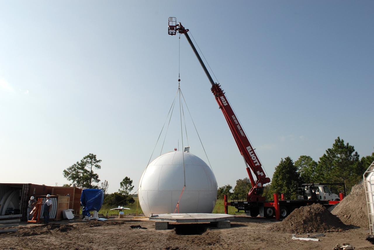CAPE CANAVERAL, Fla. -  In an area near S.R. 520 in Orange County, Florida, a crane begins lifting a radar dome, or radome, which is part of a new Doppler weather radar facility for the 45th Weather Squadron.  The new site replaces one at Patrick Air Force Base.  It will be used by NASA's Kennedy Space Center, the 45th Space Wing and their customers. The site will be able to monitor weather conditions directly above the launch pads at Kennedy. The weather radar is essential in issuing lightning and other severe weather warnings and vital in evaluating lightning launch commit criteria.  The new radar, replacing what was installed 25 years ago at Patrick Air Force Base, includes Doppler capability to detect winds and identify the type, size and number of precipitation particles.  The site is ideally distant from the launch pads and has unobstructed views of Cape Canaveral Air Force Station and Kennedy. The radar will be used by forecasters at the USAF 45th Weather Squadron. Photo credit: NASA/Troy Cryder