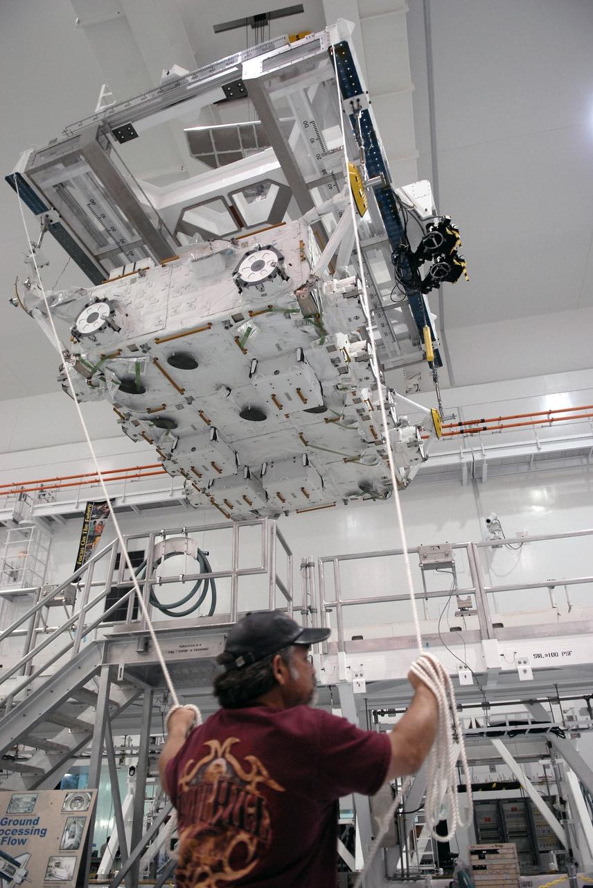 CAPE CANAVERAL, Fla. – In the Space Station Processing Facility at NASA's Kennedy Space Center in Florida, a worker help guides the progress of the Japan Aerospace Exploration Agency's Kibo Exposed Facility, or EF, as it moves across the room to another stand. The EF, along with the Experiment Logistics Module Exposed Section, will be carried aboard space shuttle Endeavour on the STS-127 mission to the International Space Station targeted for launch May 15, 2009. When it is installed on the Kibo laboratory,the EF will provide a multipurpose platform where science experiments can be deployed and operated in the exposed environment. The payloads attached to the EF can be exchanged or retrieved by Kibo's robotic arm, the JEM Remote Manipulator System. Photo credit: NASA/Kim Shiflett