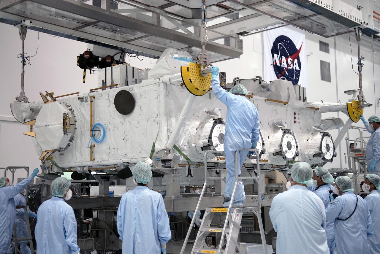 CAPE CANAVERAL, Fla. – In the Space Station Processing Facility at NASA's Kennedy Space Center in Florida, workers check the placement of the Japan Aerospace Exploration Agency's Kibo Exposed Facility, or EF, on the stand. The EF, along with the Experiment Logistics Module Exposed Section, will be carried aboard space shuttle Endeavour on the STS-127 mission to the International Space Station targeted for launch May 15, 2009. When it is installed on the Kibo laboratory,the EF will provide a multipurpose platform where science experiments can be deployed and operated in the exposed environment. The payloads attached to the EF can be exchanged or retrieved by Kibo's robotic arm, the JEM Remote Manipulator System. Photo credit: NASA/Kim Shiflett