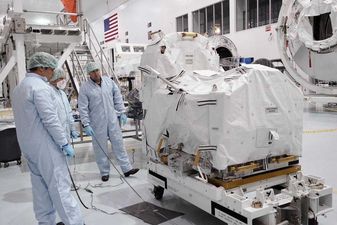 CAPE CANAVERAL, FIa. -- In the Space Station Processing Facility at NASA's Kennedy Space Center, astronauts Robert Behnken (left) and Michael Foreman (right) inspect the flexible hose rotary coupler that will fly on the STS-126 mission Nov. 14. Although not associated with the mission, Foreman and Behnken are crew members of the EVA branch who are providing their expertise for hardware going on the International Space Station. On the STS-126 mission, space shuttle Endeavour will deliver a Multi-Purpose Logistics Module to the International Space Station. Photo credit: NASA/Kim Shiflett