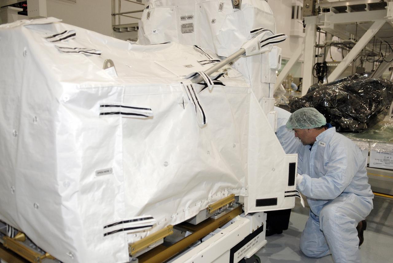 CAPE CANAVERAL, FIa. -- In the Space Station Processing Facility at NASA's Kennedy Space Center, astronaut Michael Foreman closely inspects the flexible hose rotary coupler that will fly on the STS-126 mission Nov. 14. Although not associated with the mission, Foreman is a crew member of the EVA branch who are providing their expertise for hardware going on the International Space Station. On the STS-126 mission, space shuttle Endeavour will deliver a Multi-Purpose Logistics Module to the International Space Station. Photo credit: NASA/Kim Shiflett