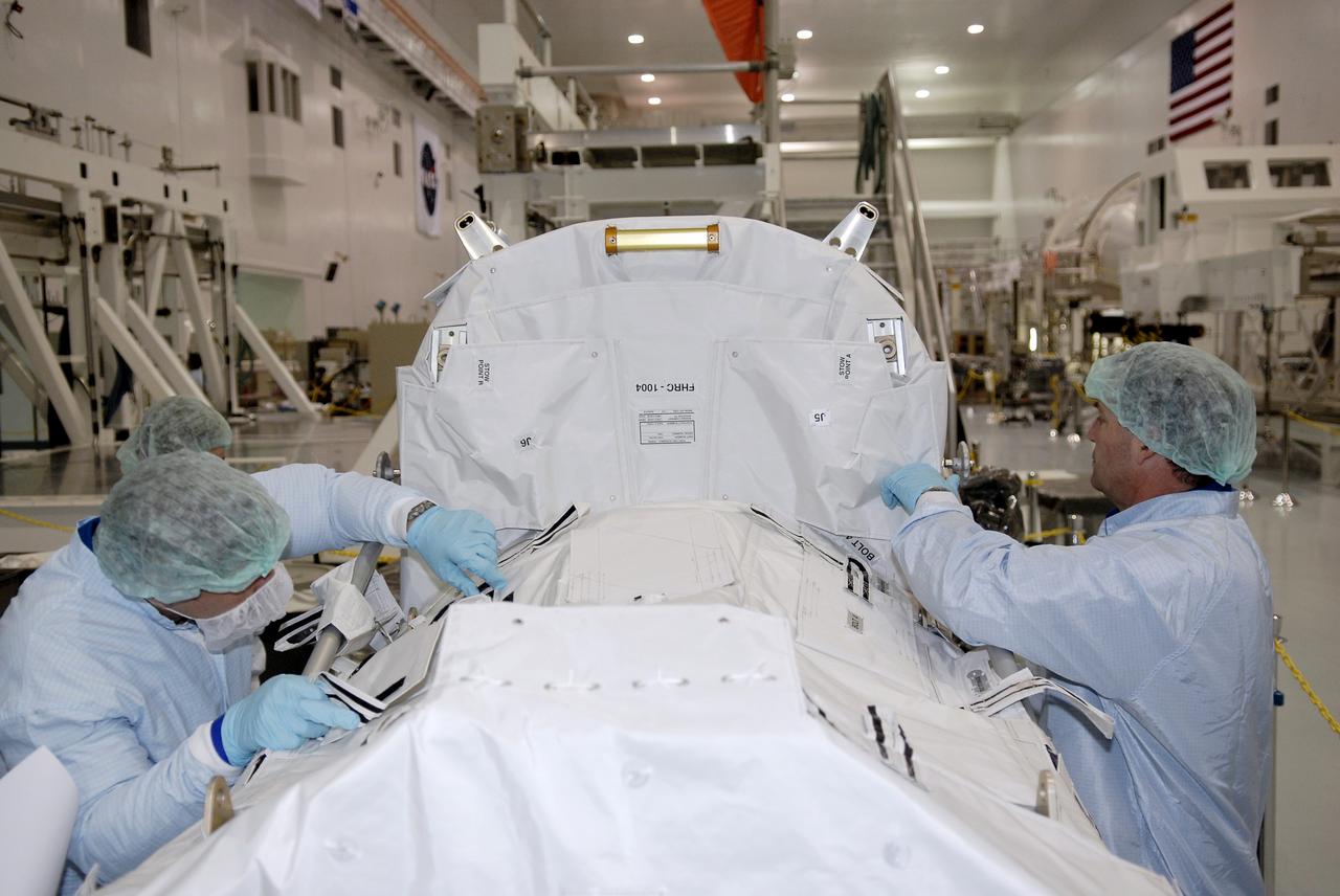 CAPE CANAVERAL, FIa. -- In the Space Station Processing Facility at NASA's Kennedy Space Center, astronauts Robert Behnken (left) and Michael Foreman (right) inspect the flexible hose rotary coupler that will fly on the STS-126 mission Nov. 14. Although not associated with the mission, Foreman and Behnken are crew members of the EVA branch who are providing their expertise for hardware going on the International Space Station. On the STS-126 mission, space shuttle Endeavour will deliver a Multi-Purpose Logistics Module to the International Space Station. Photo credit: NASA/Kim Shiflett