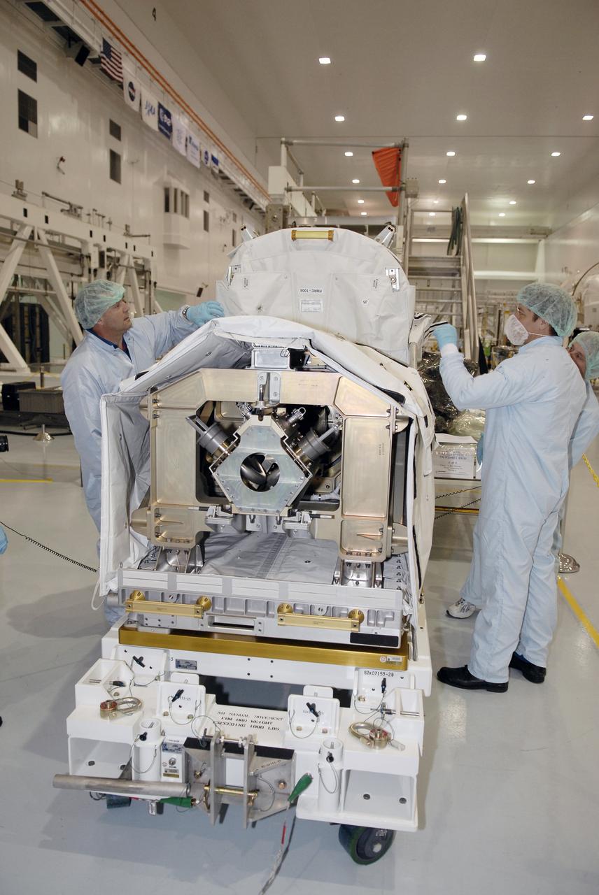 CAPE CANAVERAL, FIa. -- In the Space Station Processing Facility at NASA's Kennedy Space Center, astronaut Michael Foreman (left) checks part of the cover on the flexible hose rotary coupler that will fly on the STS-126 mission Nov. 14. Although not associated with the mission, Foreman is an EVA branch crew member providing expertise for hardware going on the International Space Station. On the STS-126 mission, space shuttle Endeavour will deliver a Multi-Purpose Logistics Module to the International Space Station. Photo credit: NASA/Kim Shiflett