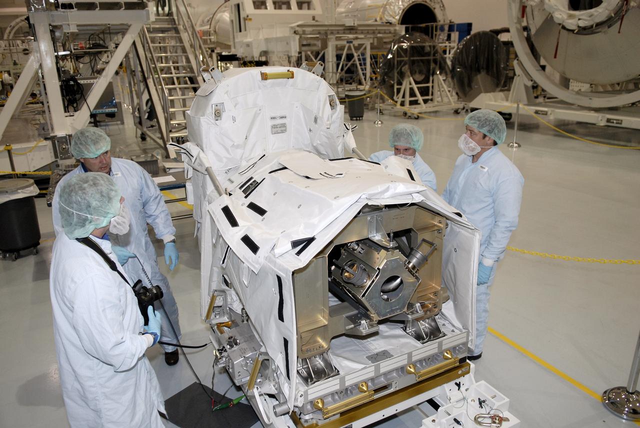 CAPE CANAVERAL, FIa. -- In the Space Station Processing Facility at NASA's Kennedy Space Center, astronauts Michael Foreman (left, in back) and Robert Behnken (far right) inspect the flexible hose rotary coupler that will fly on the STS-126 mission Nov. 14. Although not associated with the mission, Foreman and Behnken are crew members of the EVA branch who are providing their expertise for hardware going on the International Space Station. On the STS-126 mission, space shuttle Endeavour will deliver a Multi-Purpose Logistics Module to the International Space Station. Photo credit: NASA/Kim Shiflett