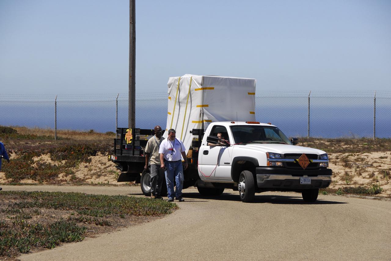VANDENBERG AIR FORCE BASE, Calif. – The Interstellar Boundary Explorer, or IBEX, spacecraft is driven from the Astrotech building in an environmentally controlled container to Hangar 1555 on Vandenberg Air Force Base in California. In the hangar, IBEX will be mated with the Pegasus XL rocket for launch. The IBEX satellite will make the first map of the boundary between the Solar System and interstellar space. IBEX is targeted for launch from the Kwajalein Atoll, a part of the Marshall Islands in the Pacific Ocean, on Oct. 19 aboard the Pegasus rocket dropped from under the wing of an L-1011 aircraft flying over the Pacific Ocean. The Pegasus will carry the spacecraft approximately 130 miles above Earth and place it in orbit. Photo credit: NASA/Dan Liberotti, VAFB