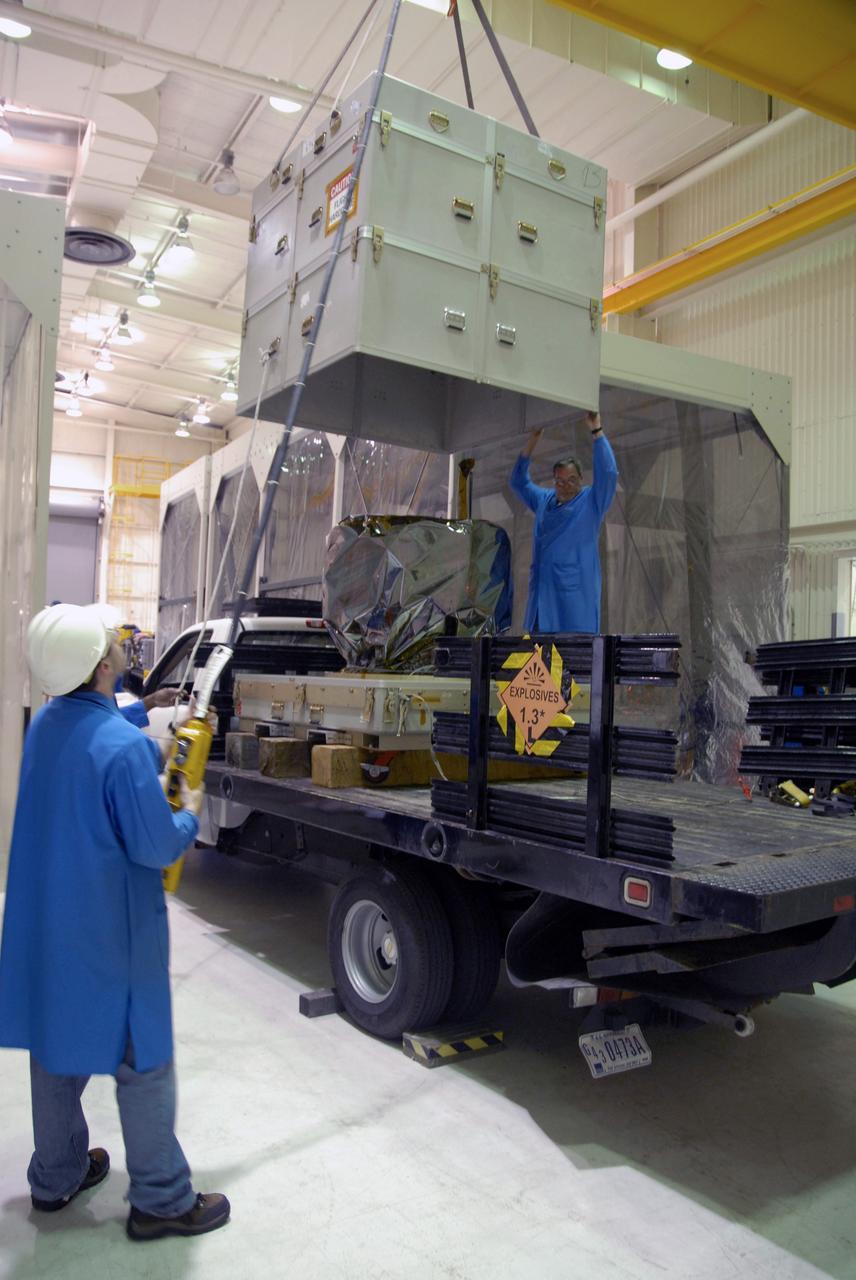 VANDENBERG AIR FORCE BASE, Calif. – The cover of the environmentally controlled container is lifted off NASA’s Interstellar Boundary Explorer, or IBEX, spacecraft after its arrival at Hangar 1555 on Vandenberg Air Force Base in California. In the hangar, IBEX will be mated with the Pegasus XL rocket for launch. The IBEX satellite will make the first map of the boundary between the Solar System and interstellar space. IBEX is targeted for launch from the Kwajalein Atoll, a part of the Marshall Islands in the Pacific Ocean, on Oct. 19 aboard the Pegasus rocket dropped from under the wing of an L-1011 aircraft flying over the Pacific Ocean. The Pegasus will carry the spacecraft approximately 130 miles above Earth and place it in orbit. Photo credit: NASA/Dan Liberotti, VAFB