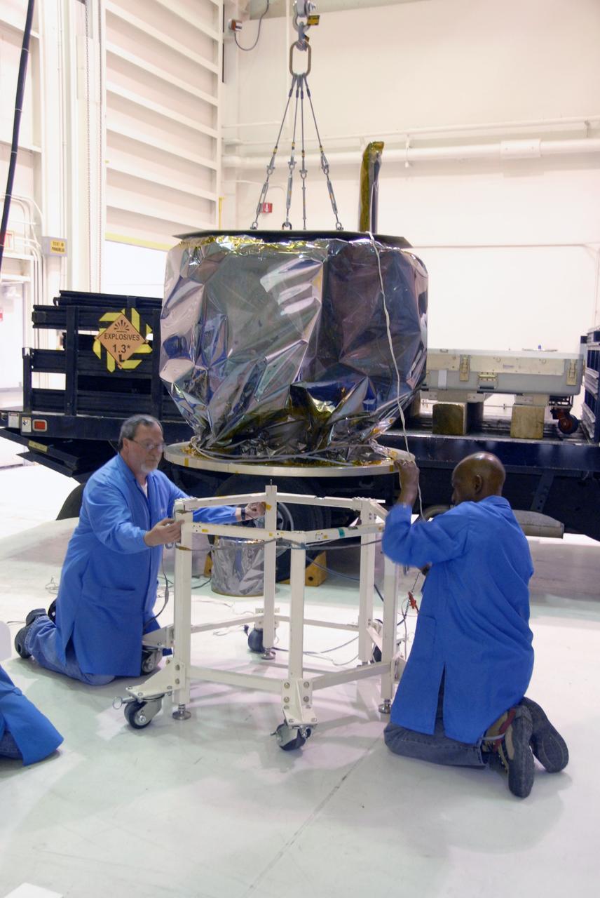 VANDENBERG AIR FORCE BASE, Calif. – In Hangar 1555 on Vandenberg Air Force Base in California, a crane lowers NASA’s Interstellar Boundary Explorer, or IBEX, spacecraft onto a moveable stand. In the hangar, IBEX will be mated with the Pegasus XL rocket for launch. The IBEX satellite will make the first map of the boundary between the Solar System and interstellar space. IBEX is targeted for launch from the Kwajalein Atoll, a part of the Marshall Islands in the Pacific Ocean, on Oct. 19 aboard the Pegasus rocket dropped from under the wing of an L-1011 aircraft flying over the Pacific Ocean. The Pegasus will carry the spacecraft approximately 130 miles above Earth and place it in orbit. Photo credit: NASA/Dan Liberotti, VAFB