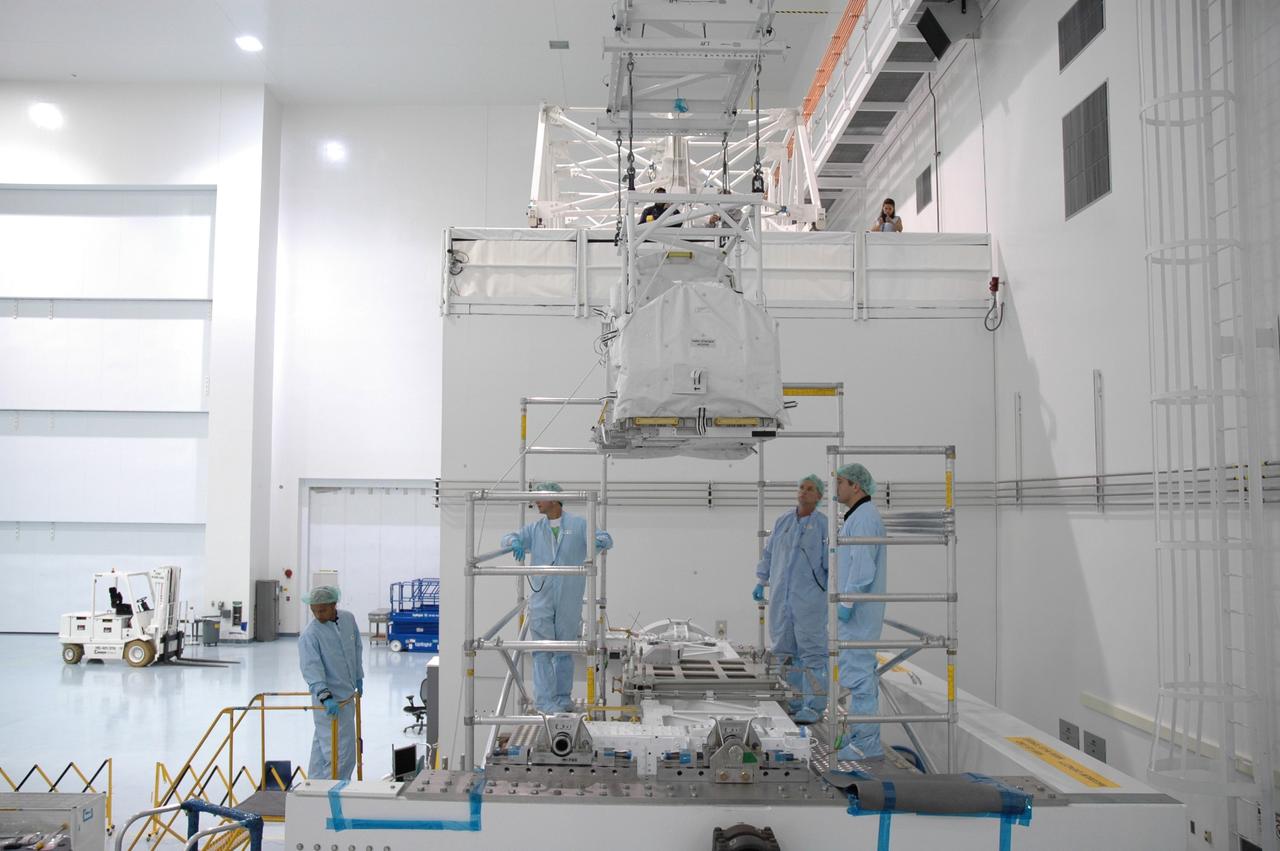 CAPE CANAVERAL, FIa. -- In the Space Station Processing Facility at NASA's Kennedy Space Center in Florida, an overhead crane moves the flexible hose rotary coupler across the floor to the Lightweight Multi-Purpose Experiment Support Structure Carrier for installation. The carrier will be installed in space shuttle Endeavour for the STS-126 mission to the International Space Station. The 15-day flight will deliver equipment and supplies to the space station in preparation for expansion from a three- to six-person resident crew aboard the complex. The mission also will include four spacewalks to service the station’s Solar Alpha Rotary Joints. Photo credit: NASA/Jim Grossmann