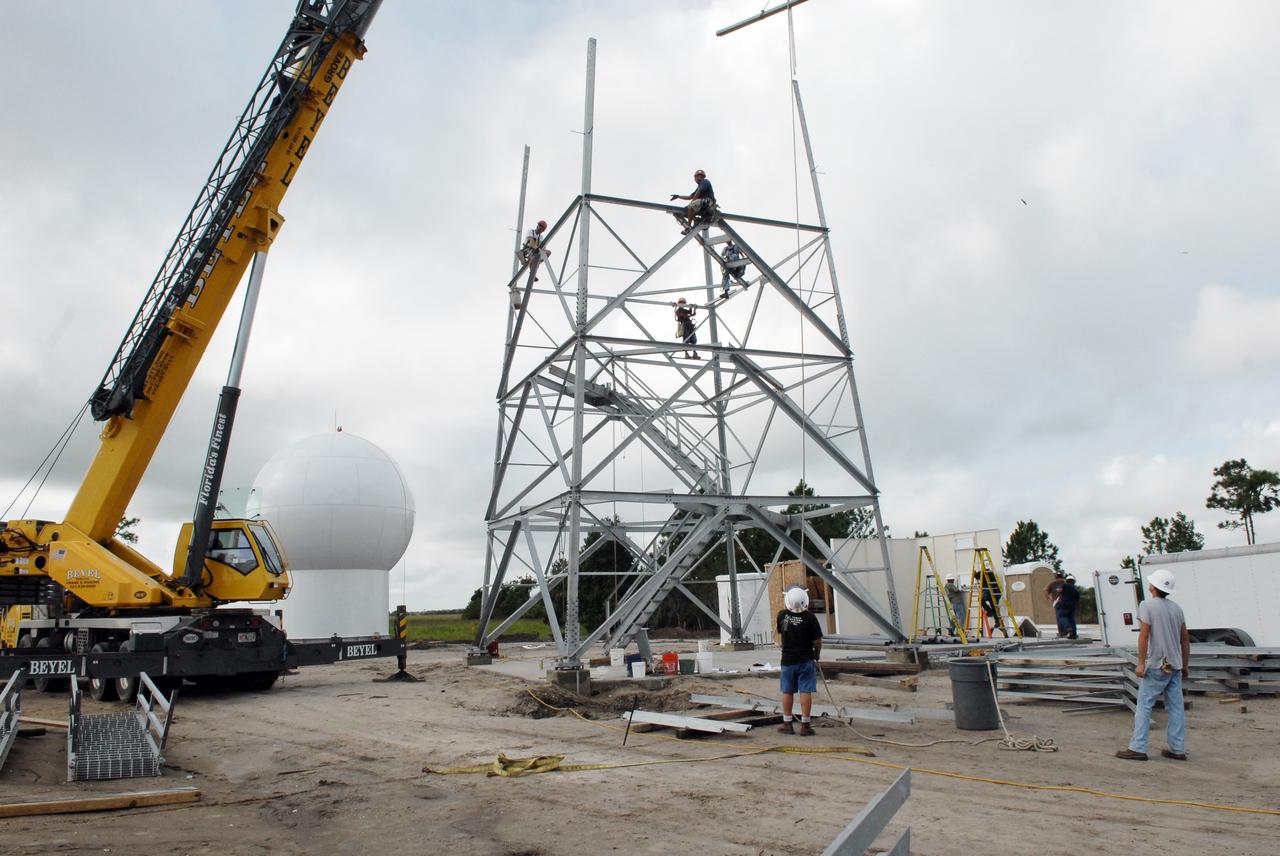 CAPE CANAVERAL, Fla. – In an area near S.R. 520 in Orange County, Florida, workers are constructing a steel tower for a Doppler weather radar facility for the 45th Weather Squadron. At left is the radome that will be on top of the tower.  The new site replaces one at Patrick Air Force Base. It will be used by NASA's Kennedy Space Center, the 45th Space Wing and their customers. The site will be able to monitor weather conditions directly above and surrounding the launch pads at Kennedy.  The weather radar is essential in issuing lightning and other severe weather warnings and vital in evaluating lightning launch commit criteria.  The new radar, replacing what was installed 25 years ago at Patrick Air Force Base, includes Doppler capability to detect winds and identify the type, size and number of precipitation particles.  The site is ideally distant from the launch pads and has unobstructed views of Cape Canaveral Air Force Station and Kennedy. The radar will be used by forecasters at the USAF 45th Weather Squadron. Photo credit: NASA/Troy Cryder