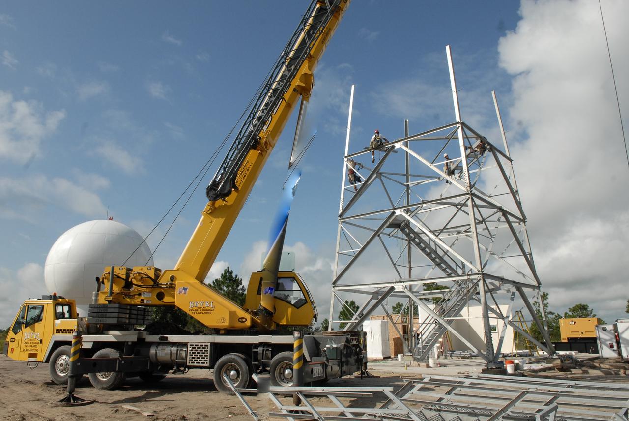 CAPE CANAVERAL, Fla. – In an area near S.R. 520 in Orange County, Florida, workers are constructing a steel tower for a Doppler weather radar facility for the 45th Weather Squadron. At left is the radome that will be on top of the tower.  The new site replaces one at Patrick Air Force Base. It will be used by NASA's Kennedy Space Center, the 45th Space Wing and their customers. The site will be able to monitor weather conditions directly above and surrounding the launch pads at Kennedy.  The weather radar is essential in issuing lightning and other severe weather warnings and vital in evaluating lightning launch commit criteria.  The new radar, replacing what was installed 25 years ago at Patrick Air Force Base, includes Doppler capability to detect winds and identify the type, size and number of precipitation particles.  The site is ideally distant from the launch pads and has unobstructed views of Cape Canaveral Air Force Station and Kennedy. The radar will be used by forecasters at the USAF 45th Weather Squadron. Photo credit: NASA/Troy Cryder