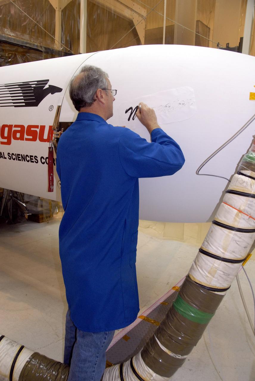 VANDENBERG AIR FORCE BASE, Calif. – In Hangar 1555 on Vandenberg Air Force Base in California, a worker begins painting the name “Mercator” on the nose of the Pegasus XL rocket. The rocket is the launch vehicle for NASA’s Interstellar Boundary Explorer, or IBEX, spacecraft. The IBEX satellite will make the first map of the boundary between the Solar System and interstellar space. The name Mercator was chosen in honor of Gerardus Mercator, the Flemish cartographer (or map maker). In addition to the many maps that he made, he also invented a technique to create terrestrial and celestial globes out of paper mache, allowing for greater production than the carved wooden or brass globes that were previously used. IBEX is targeted for launch from the Kwajalein Atoll, a part of the Marshall Islands in the Pacific Ocean, on Oct. 19. IBEX will be launched aboard the Pegasus rocket dropped from under the wing of an L-1011 aircraft flying over the Pacific Ocean. The Pegasus will carry the spacecraft approximately 130 miles above Earth and place it in orbit. Photo credit: NASA/R. Bledsoe, VAFB