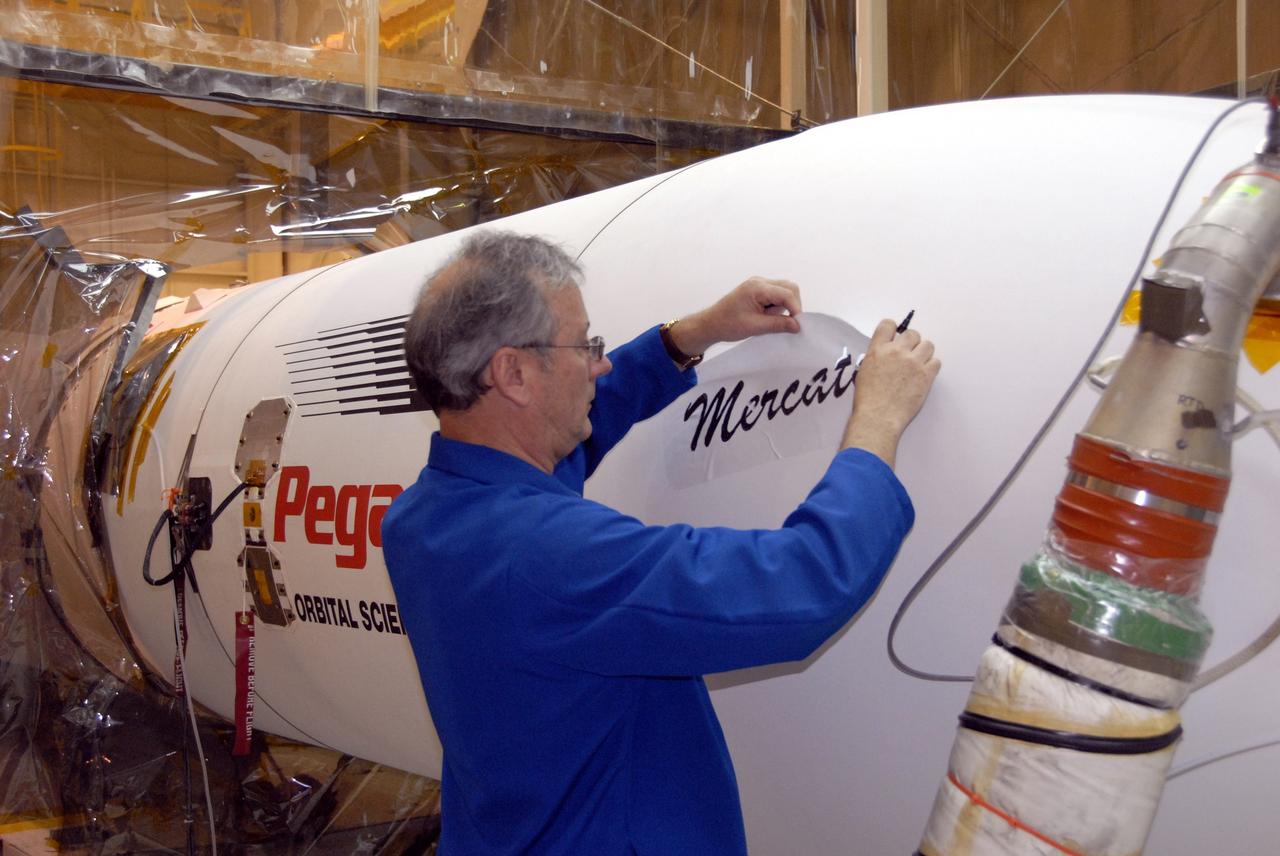 VANDENBERG AIR FORCE BASE, Calif. – In Hangar 1555 on Vandenberg Air Force Base in California, a worker paints the name “Mercator” on the nose of the Pegasus XL rocket. The rocket is the launch vehicle for NASA’s Interstellar Boundary Explorer, or IBEX, spacecraft. The IBEX satellite will make the first map of the boundary between the Solar System and interstellar space. The name Mercator was chosen in honor of Gerardus Mercator, the Flemish cartographer (or map maker). In addition to the many maps that he made, he also invented a technique to create terrestrial and celestial globes out of paper mache, allowing for greater production than the carved wooden or brass globes that were previously used. IBEX is targeted for launch from the Kwajalein Atoll, a part of the Marshall Islands in the Pacific Ocean, on Oct. 19. IBEX will be launched aboard the Pegasus rocket dropped from under the wing of an L-1011 aircraft flying over the Pacific Ocean. The Pegasus will carry the spacecraft approximately 130 miles above Earth and place it in orbit. Photo credit: NASA/R. Bledsoe, VAFB