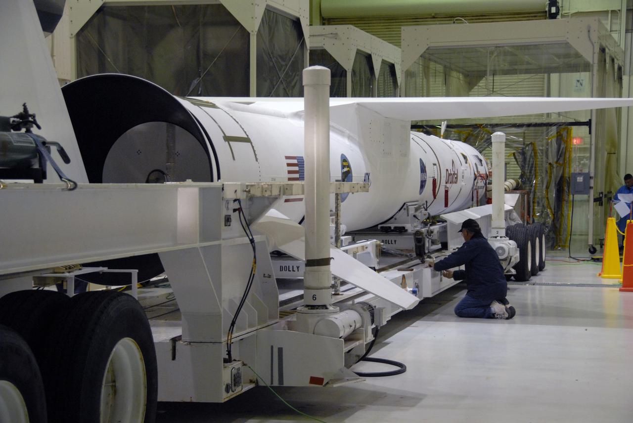 VANDENBERG AIR FORCE BASE, Fla. -- In Hangar 1555, work is under way preparing NASA’s Interstellar Boundary Explorer, or IBEX, spacecraft and mated Pegasus XL rocket on its transporter for a trip to the ramp on Vandenberg Air Force Base in California. There, the rocket-spacecraft will be attached to the L-1011 aircraft. IBEX is targeted for launch from the Kwajalein Atoll, a part of the Marshall Islands in the Pacific Ocean, on Oct. 19. IBEX will be launched aboard the Pegasus rocket dropped from under the wing of the L-1011 aircraft flying over the Pacific Ocean. The Pegasus will carry the spacecraft approximately 130 miles above Earth and place it in orbit. The IBEX satellite will make the first map of the boundary between the Solar System and interstellar space. Photo credit: NASA/Mark Mackley, VAFB