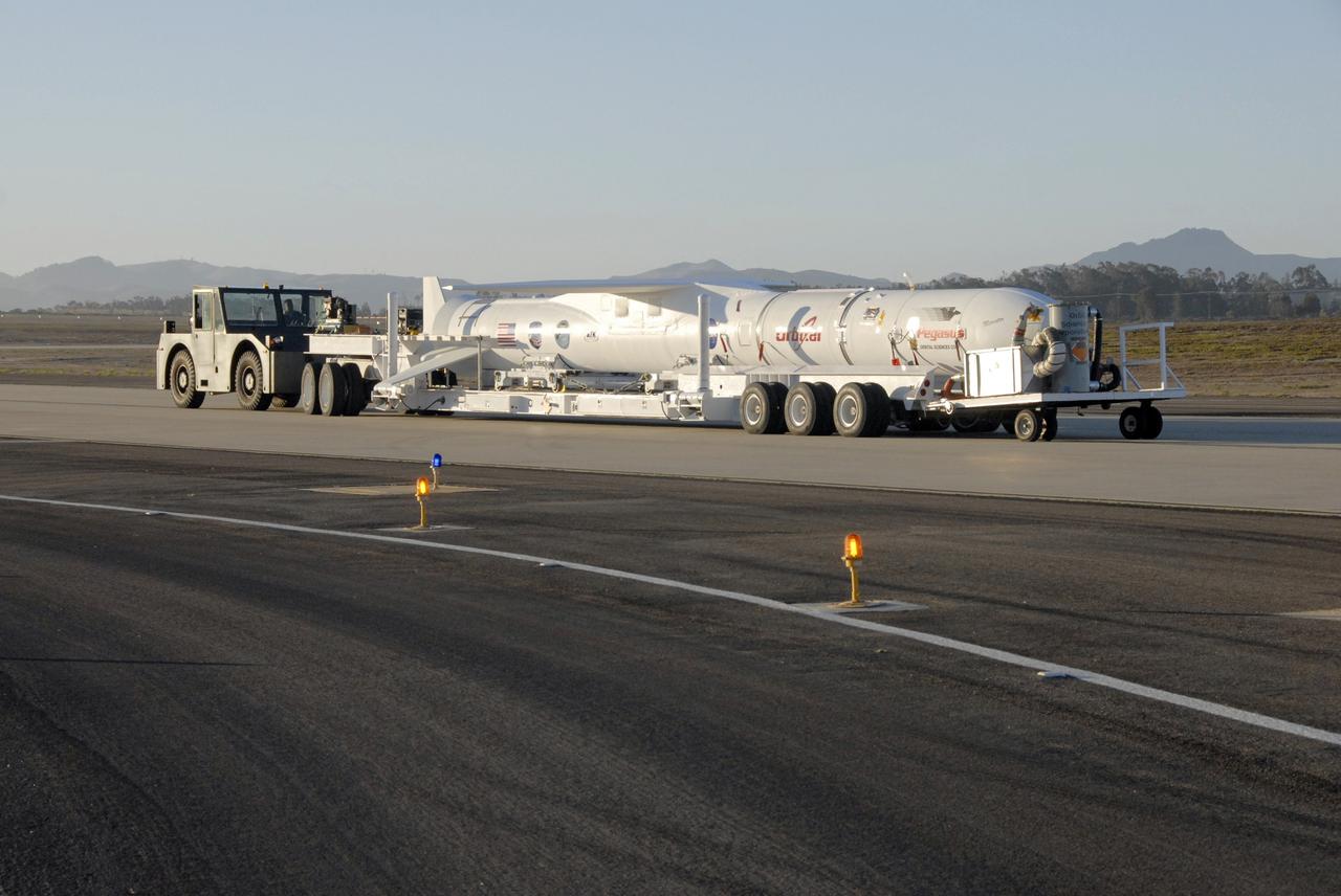VANDENBERG AIR FORCE BASE, Fla. -- NASA’s Interstellar Boundary Explorer, or IBEX, spacecraft and mated Pegasus XL rocket are transported to the ramp on Vandenberg Air Force Base in California. There, the rocket will be attached to Orbital Sciences’ L-1011 aircraft for launch. IBEX is targeted for launch from the Kwajalein Atoll, a part of the Marshall Islands in the Pacific Ocean, on Oct. 19. IBEX will be launched aboard the Pegasus rocket dropped from under the wing of the L-1011 aircraft flying over the Pacific Ocean. The Pegasus will carry the spacecraft approximately 130 miles above Earth and place it in orbit. The IBEX satellite will make the first map of the boundary between the Solar System and interstellar space. Photo credit: NASA/Mark Mackley, VAFB