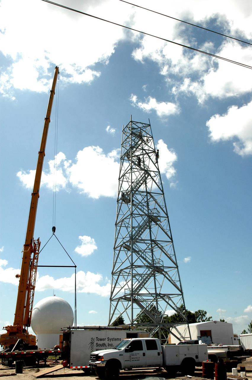 CAPE CANAVERAL, Fla. – In an area near S.R. 520 in Orange County, Florida, the steel tower for a Doppler weather radar facility for the 45th Weather Squadron is nearly complete. At left is the radome that will go on top of the tower, enclosing the radar. The new site replaces one at Patrick Air Force Base and will be used by NASA's Kennedy Space Center, the U.S. Air Force's 45th Space Wing and their customers. The facility will be able to monitor weather conditions directly above and surrounding the launch pads at Kennedy.  The weather radar is essential in issuing lightning and other severe weather warnings and vital in evaluating lightning launch commit criteria.  Replacing what was installed 25 years ago at Patrick Air Force Base, the new radar includes Doppler capability to detect winds and identify the type, size and number of precipitation particles.  The site is ideally distant from the launch pads and has unobstructed views of Cape Canaveral Air Force Station and Kennedy. The radar will be used by forecasters at the USAF 45th Weather Squadron.  Photo credit: NASA/Jim Grossmann