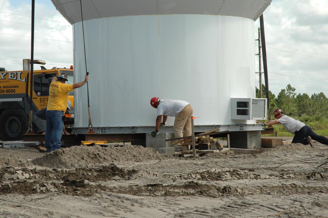 CAPE CANAVERAL, Fla. – In an area near S.R. 520 in Orange County, Florida, workers help position a radome onto concrete blocks.  The radome will be lifted onto a steel tower constructed for a Doppler weather radar for the 45th Weather Squadron. The new site replaces one at Patrick Air Force Base and will be used by NASA's Kennedy Space Center, the U.S. Air Force's 45th Space Wing and their customers. The facility will be able to monitor weather conditions directly above and surrounding the launch pads at Kennedy.  The weather radar is essential in issuing lightning and other severe weather warnings and vital in evaluating lightning launch commit criteria.  Replacing what was installed 25 years ago at Patrick Air Force Base, the new radar includes Doppler capability to detect winds and identify the type, size and number of precipitation particles.  The site is ideally distant from the launch pads and has unobstructed views of Cape Canaveral Air Force Station and Kennedy. The radar will be used by forecasters at the USAF 45th Weather Squadron.  Photo credit: NASA/Jim Grossmann