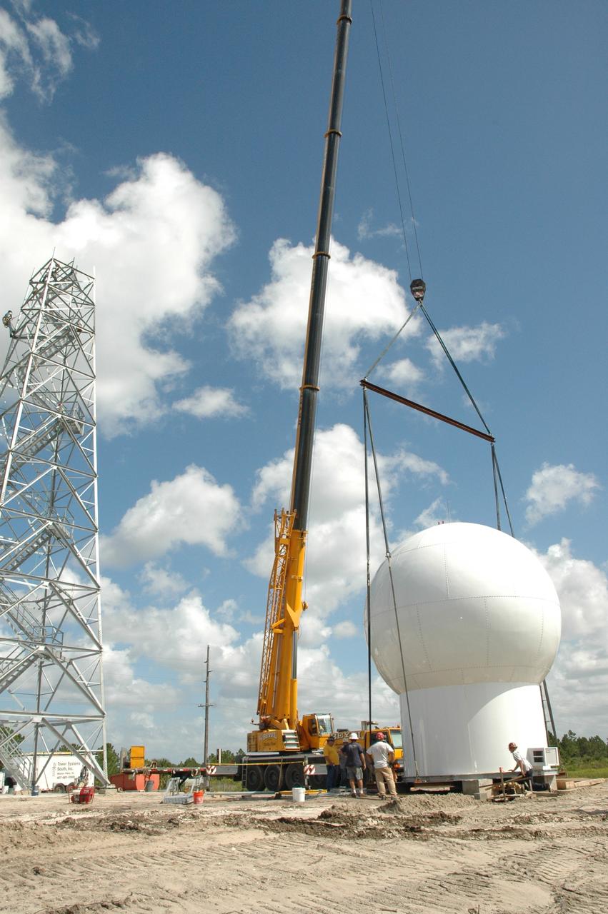 CAPE CANAVERAL, Fla. – In In an area near S.R. 520 in Orange County, Florida, a crane is used to position a radome on concrete blocks.  The radome will be lifted onto a steel tower constructed for a Doppler weather radar for the 45th Weather Squadron. The new site replaces one at Patrick Air Force Base and will be used by NASA's Kennedy Space Center, the U.S. Air Force's 45th Space Wing and their customers. The facility will be able to monitor weather conditions directly above and surrounding the launch pads at Kennedy.  The weather radar is essential in issuing lightning and other severe weather warnings and vital in evaluating lightning launch commit criteria.  Replacing what was installed 25 years ago at Patrick Air Force Base, the new radar includes Doppler capability to detect winds and identify the type, size and number of precipitation particles.  The site is ideally distant from the launch pads and has unobstructed views of Cape Canaveral Air Force Station and Kennedy. The radar will be used by forecasters at the USAF 45th Weather Squadron.  Photo credit: NASA/Jim Grossmann