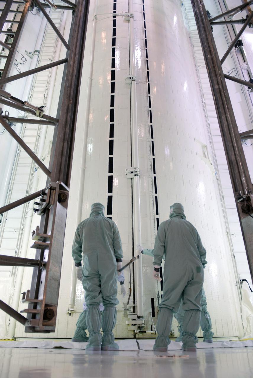 CAPE CANAVERAL, Fla. –   On Launch Pad 39A on NASA's Kennedy Space Center in Florida, workers ensure the doors of the payload canister are closed.  Space shuttle Atlantis’ HST payload for the STS-125 mission was moved from the shuttle into the canister. The payload comprises four carriers holding various equipment for the mission.  The hardware will be transported back to Kennedy’s Payload Hazardous Servicing Facility where it will be stored until a new target launch date can be set for Atlantis’ STS-125 mission in 2009.  Atlantis’ October target launch date was delayed after a device on board Hubble used in the storage and transmission of science data to Earth shut down on Sept. 27.  Replacing the broken device will be added to Atlantis’ servicing mission to the telescope. Photo credit: NASA/Kim Shiflett