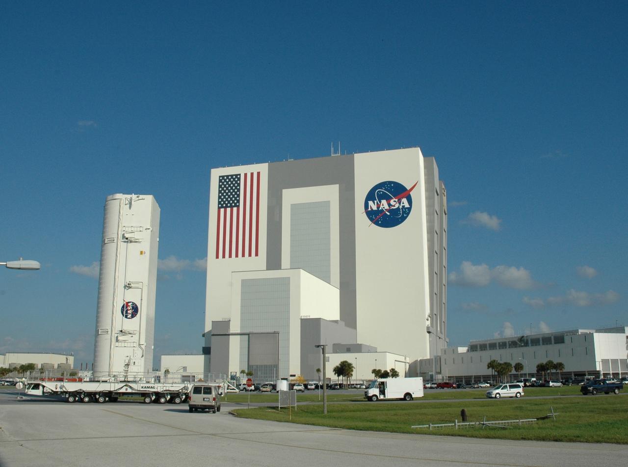 CAPE CANAVERAL, Fla. – On NASA's Kennedy Space Center in Florida, the canister with space shuttle Atlantis’ HST payload inside makes the turn past the Vehicle Assembly Building onto Kennedy Parkway. The payload comprises four carriers holding various equipment for the mission. The hardware will be transported back to Kennedy’s Payload Hazardous Servicing Facility where it will be stored until a new target launch date can be set for Atlantis’ STS-125 mission in 2009. Atlantis’ October target launch date was delayed after a device on board Hubble used in the storage and transmission of science data to Earth shut down on Sept. 27. Replacing the broken device will be added to Atlantis’ servicing mission to the telescope. Photo credit: NASA/Tim Jacobs