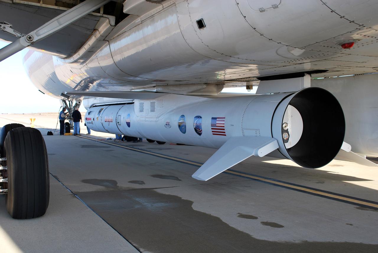 VANDENBERG AIR FORCE BASE, Calif. – On the ramp of Vandenberg Air Force Base in California, workers make final checks of the Pegasus XL rocket before departure for the Kwajalein Atoll, a part of the Marshall Islands in the Pacific Ocean.  Mated to NASA’s Interstellar Boundary Explorer, or IBEX, spacecraft, the Pegasus is attached under the wing of the aircraft for launch.   Departing from Kwajalein, the Pegasus rocket will be dropped from under the wing of the L-1011 over the Pacific Ocean to carry the spacecraft approximately 130 miles above Earth and place it in orbit.  Then, the spacecraft’s own engine will boost it to its final high-altitude orbit (about 200,000 miles high) — most of the way to the Moon. The IBEX satellite will make the first map of the boundary between the Solar System and interstellar space.  IBEX science will be led by the Southwest Research Institute of San Antonio, Texas.  IBEX is targeted for launch over the Pacific Oct. 19.   Photo credit: NASA/Randy Beaudoin, VAFB